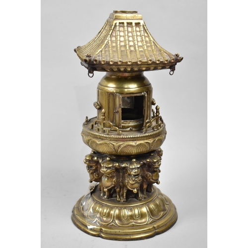 105 - A Far Eastern Brass Temple Censer in the Form of Pagoda with Hinged Doors Supported by Eight Temple ... 