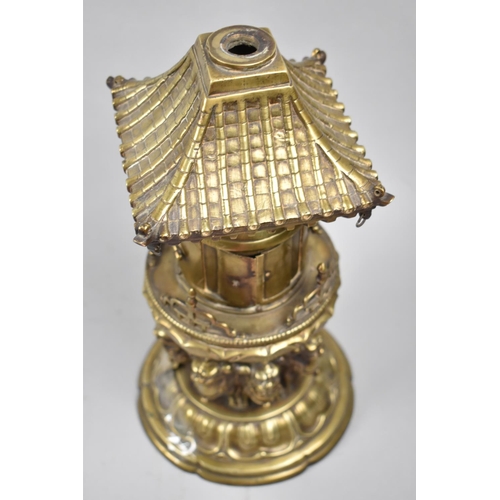 105 - A Far Eastern Brass Temple Censer in the Form of Pagoda with Hinged Doors Supported by Eight Temple ... 