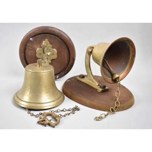 144 - Two Brass Bells on Wooden Wall Hanging Supports, Tallest 23cms High