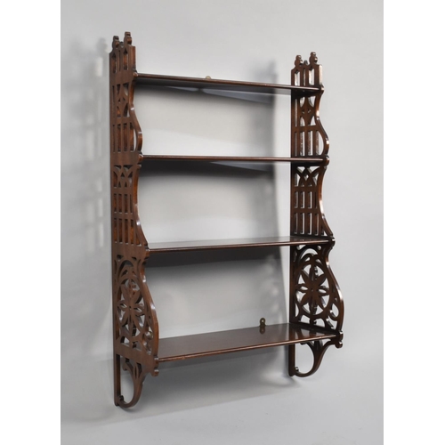 173 - A Reproduction Mahogany Four Shelf Waterfall Wall Hanging Unit with Pierced Supports, 51cms Wide