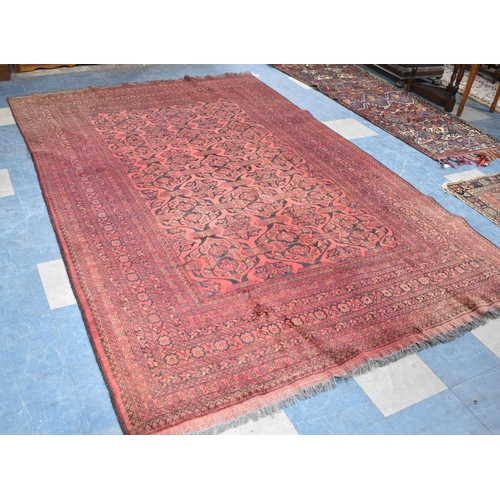 490 - A Vintage Afghan Handmade Carpet on Red Ground, 292x198cm