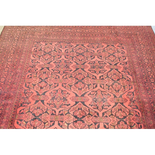 490 - A Vintage Afghan Handmade Carpet on Red Ground, 292x198cm