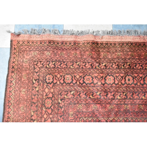 490 - A Vintage Afghan Handmade Carpet on Red Ground, 292x198cm