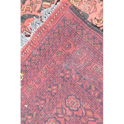 490 - A Vintage Afghan Handmade Carpet on Red Ground, 292x198cm