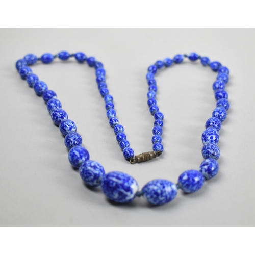 373 - A Vintage Blue and White Glass Necklace Having Graduated Oval Beads in the Venetian Style, 72cm Long