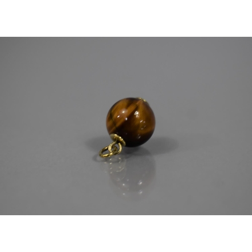49 - A 9ct Gold Mounted Tigers Eye Spherical Charm, 12mm Diameter, Stamped HS and with Import Mark for Bi... 