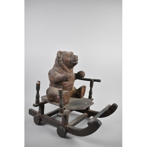 67 - A Vintage Black Forest Carved Wooden Pull Along Toy in the Form of a Seated Bear Cub on Sledge, 41cm... 