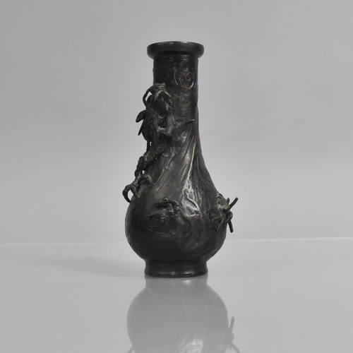 276 - A Small Japanese Bronze Bottle Vase, Decorated in Relief with Crawling Dragon, 14cms High