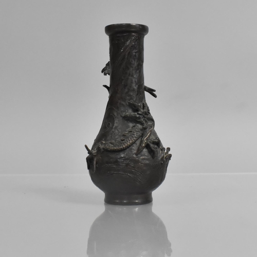 276 - A Small Japanese Bronze Bottle Vase, Decorated in Relief with Crawling Dragon, 14cms High