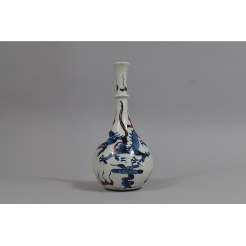 365 - A Chinese Porcelain Bottle Neck Vase Decorated with Blue Dragons and Red Highlights, Leaf Mark to Ba... 