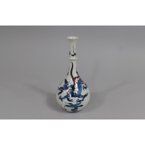 365 - A Chinese Porcelain Bottle Neck Vase Decorated with Blue Dragons and Red Highlights, Leaf Mark to Ba... 