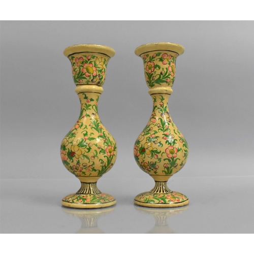 140 - A Pair of Kashmiri Candlesticks decorated in Polychrome Enamels with Floral Design on Cream Ground, ... 