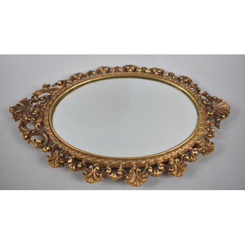 110 - A Small Brass Framed Oval Wall Mirror, 34cms High