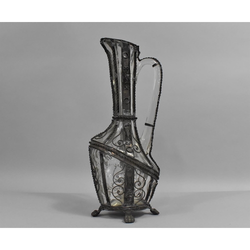 129 - A Continental Wire Mounted Glass Claret Jug with Hinged Lid and Claw Feet, 32cms High