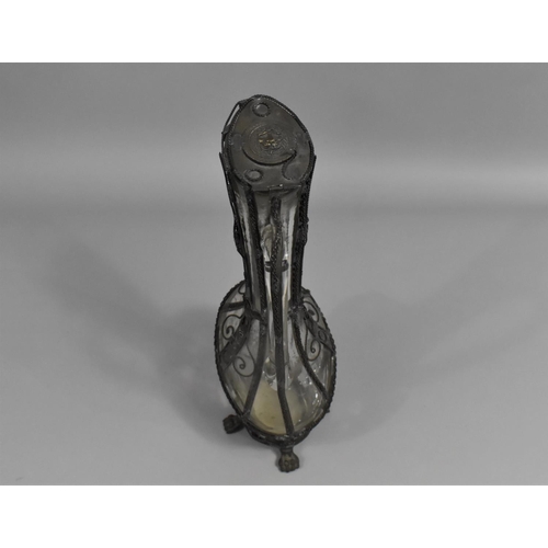 129 - A Continental Wire Mounted Glass Claret Jug with Hinged Lid and Claw Feet, 32cms High