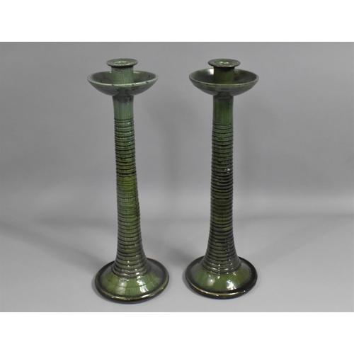 132 - A Pair of Green Glazed Terracotta Candlesticks, 43cms High