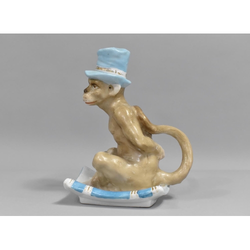 356 - A Continental Porcelain Novelty Bed Chamberstick In the form of an Anthropomorphic Monkey with Blue ... 