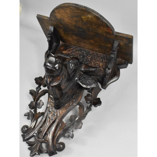 49 - An Early 20th Century Carved Black Forest Wall Shelf with Bulls Head, Pierced Back Plate, 28cms Wide... 