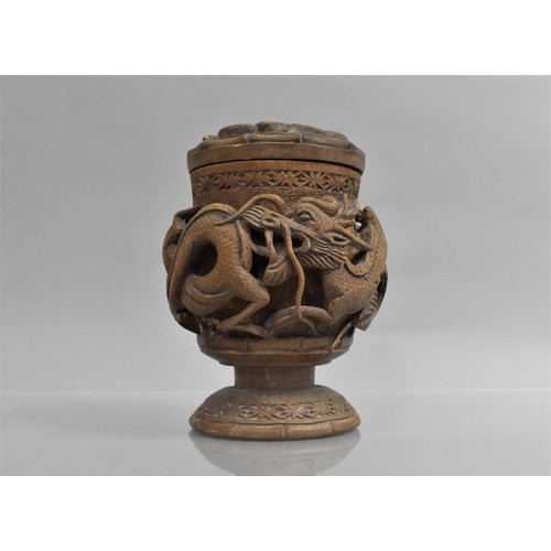 377 - A Chinese Carved Hardwood Pot and Cover Decorated in Relief with Dragon on Circular Base, 16cms High