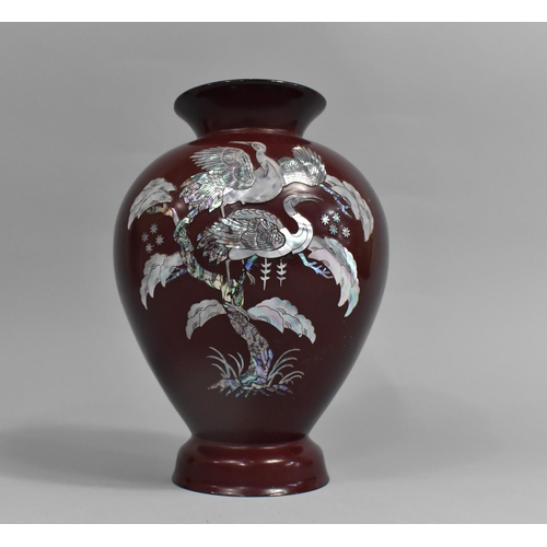 207 - A Red Lacquer and Mother of Pearl Inlaid Vase of Baluster Form Decorated with Cranes, 25cm high