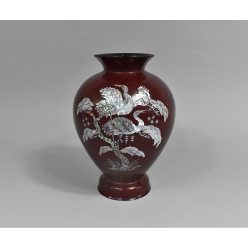 207 - A Red Lacquer and Mother of Pearl Inlaid Vase of Baluster Form Decorated with Cranes, 25cm high