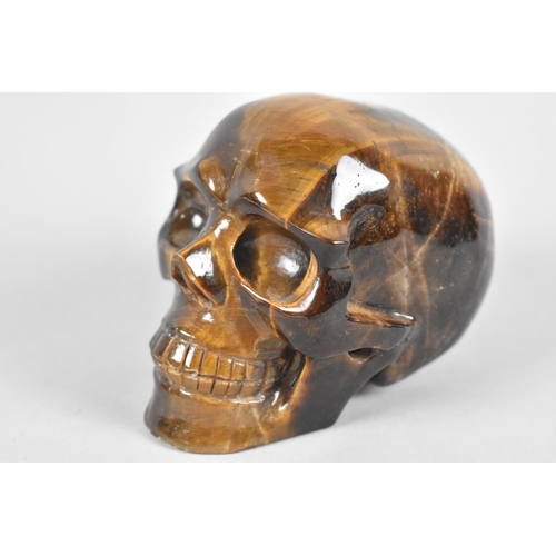 217 - A Reproduction Carved Tigers Eye Skull, 7cm high