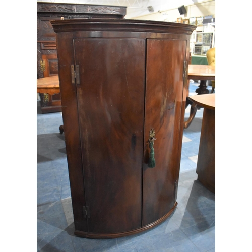 433 - A 19th Century Mahogany Bow Fronted Corner Cabinet with Brass H Hinges, 72.5cms Wide and 110cms High