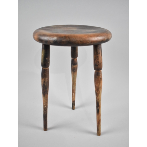 75 - A Small Circular Topped Stool on Tapering Turned Legs, 20cms Diameter and 31cms High
