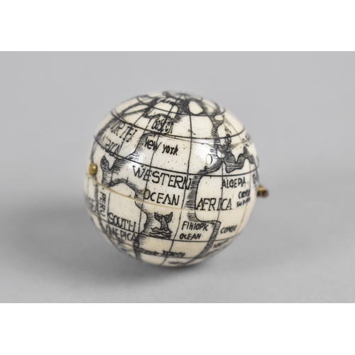 337 - A Reproduction Small Bone Scrimshaw Style Compass in the form of a Hinged Globe, 3.5cm Diameter