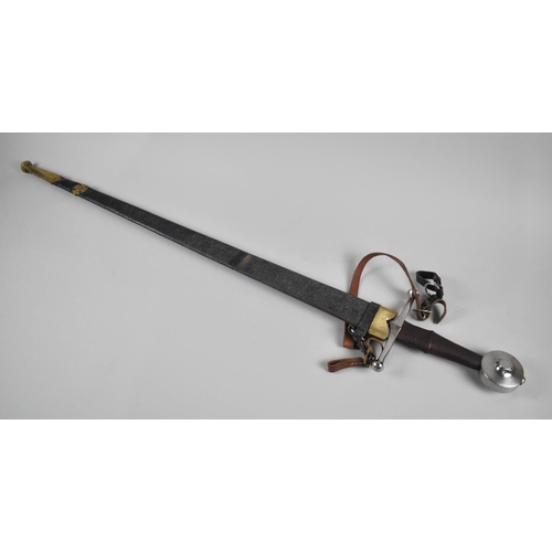 62 - A Reproduction Broad Sword in Brass Mounted Leather Scabbard