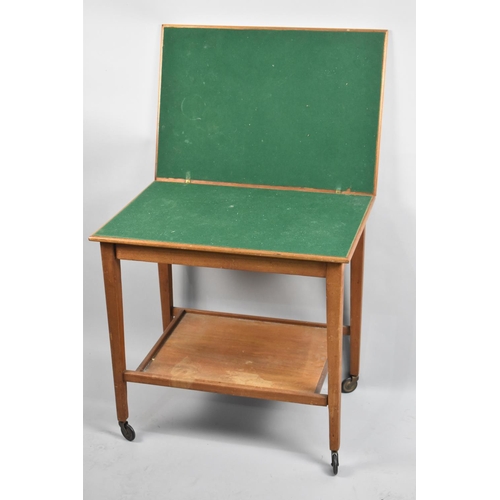 131 - A Mid 20th Century Lift and Twist Games Table with Stretcher Shelf, 66cm wide