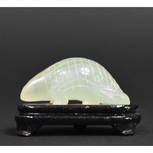 256 - A Chinese Jadeite Study of a Pangolin on Wooden Stand, 6cm wide