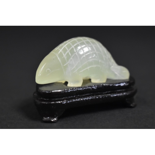 256 - A Chinese Jadeite Study of a Pangolin on Wooden Stand, 6cm wide