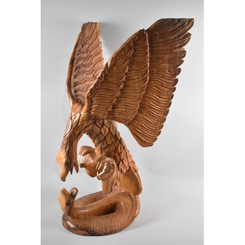 66 - A Large Carved Wooden Study of Eagle Attacking Snake, 86cm high