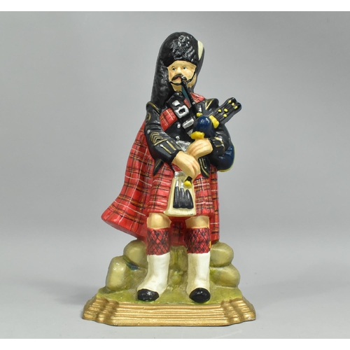 63 - A Modern Reproduction Painted Cast Iron Doorstop in the Form of a Scottish Piper, 28cms High