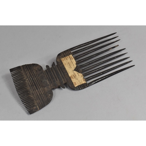 158 - A 19th Century African Tribal Comb with Roudel Design having Paper Label. 24.5cms Long