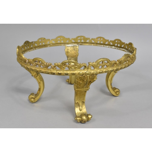 174 - A Gilt Metal Circular Stand on Four Scrolled Feet, 23cm Diameter