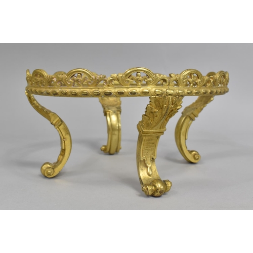 174 - A Gilt Metal Circular Stand on Four Scrolled Feet, 23cm Diameter