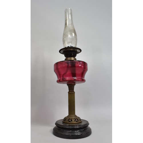 19 - A Late Victorian Brass and Cranberry Glass Oil Lamp with Ribbed Column Support, Dual Controls, Glass... 