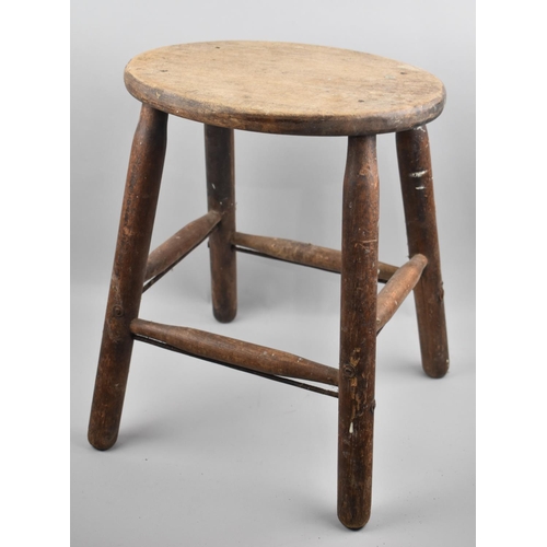 63 - A Late 19th/Early 20th Century Oval Topped Stool on Turned Supports with Stretchers, 42cms High