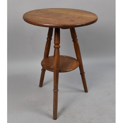 66 - An Edwardian Circular Topped Tripod Table With Stretcher Shelf, 45cms Diameter and 60ms High