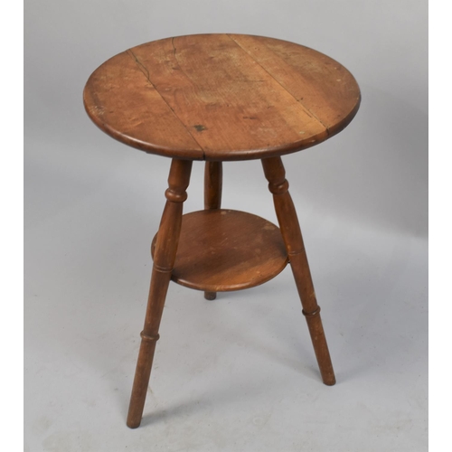 66 - An Edwardian Circular Topped Tripod Table With Stretcher Shelf, 45cms Diameter and 60ms High