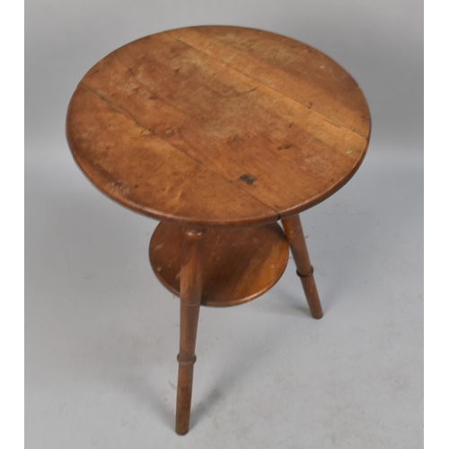 66 - An Edwardian Circular Topped Tripod Table With Stretcher Shelf, 45cms Diameter and 60ms High