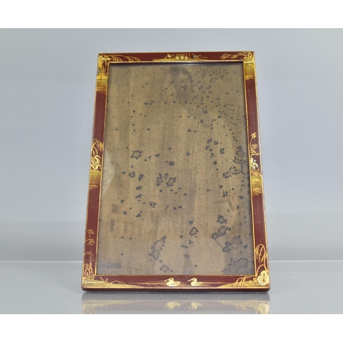 76 - An Early 20th Century Chinoiserie Lacquer Photograph Frame with Gilt Decoration on a Red Ground, 21c... 