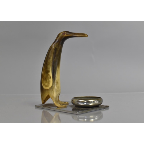 55 - An Early 20th Century Art Deco Smoker's Companion, A Carved Horn Penguin with Glass Eyes Mounted on ... 