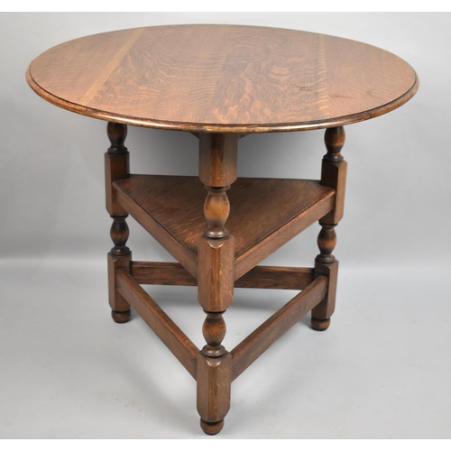 124 - A Mid 20th Century Circular Topped Oak Cricket Table with Stretcher Shelf, 70cms Diameter