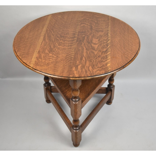 124 - A Mid 20th Century Circular Topped Oak Cricket Table with Stretcher Shelf, 70cms Diameter