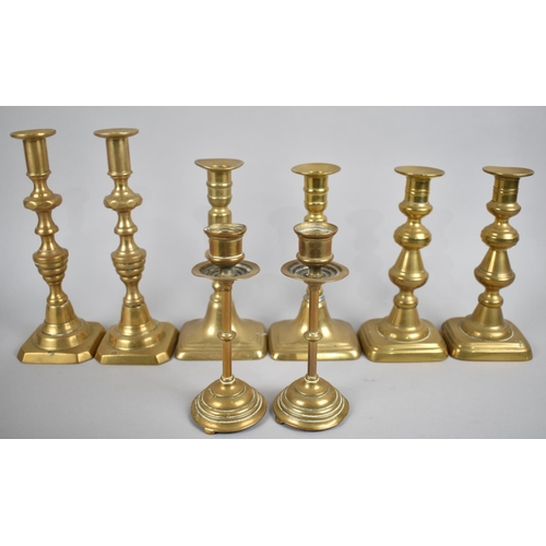 214 - A Collection of Four Pairs of Brass Candlesticks, Late 19th/Early 20th Century, Tallest 23cms High