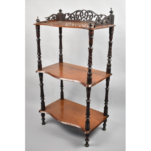 22 - A Late 19th century Three Tier Whatnot with Serpentine Fronted Shelves, Galleried Top and Turned Sup... 