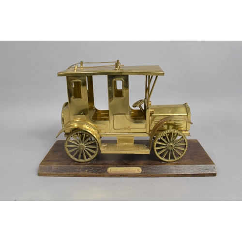 31 - A Mid 20th Century Brass Model of a Vintage Taxi on Wooden Plinth, 33cms Long